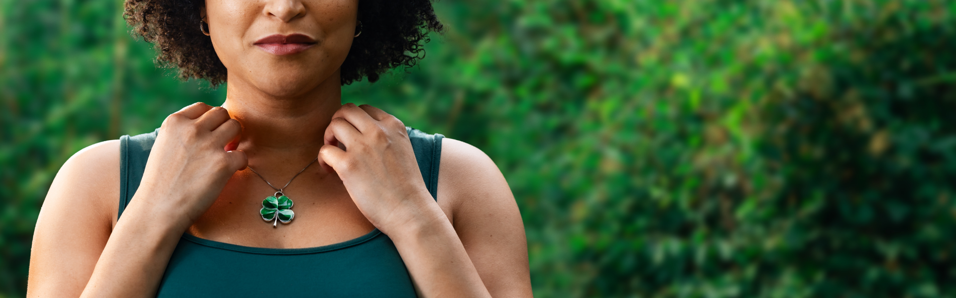 Woman contemplating the luck that her four-leaf clover necklace could bring her; it's not luck, it's ILARIS